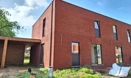 Modern semi-detached house in red brick.