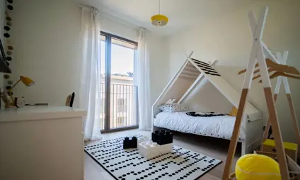 Compact children's bedroom in Quartier Bleu apartment.