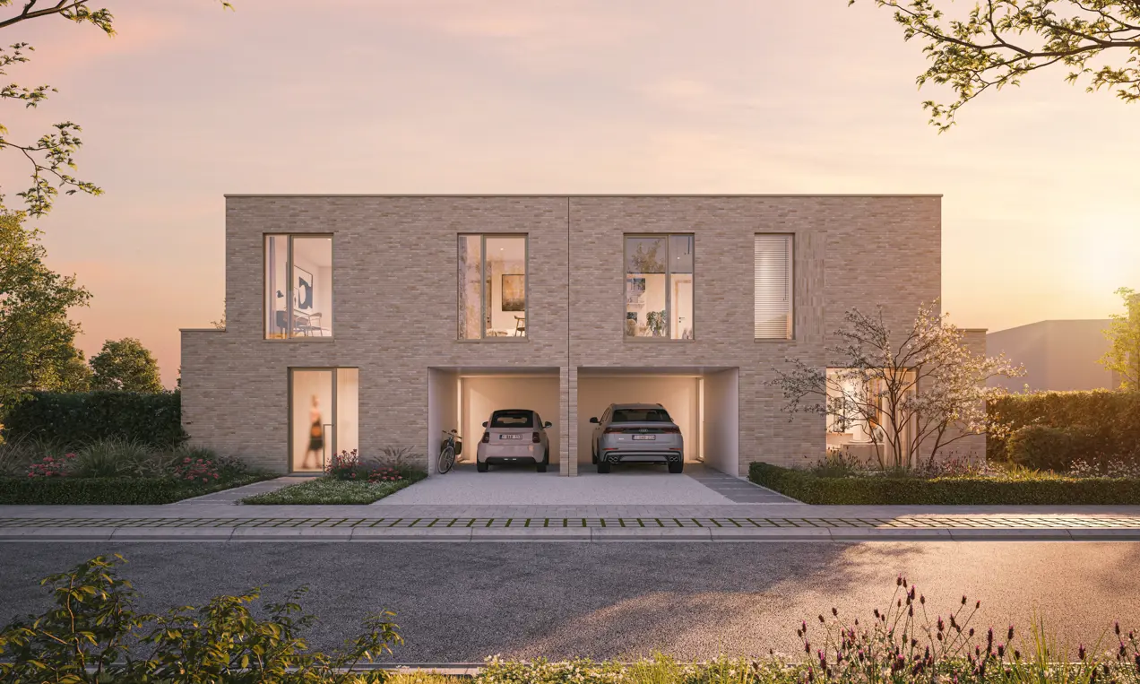 Modern duplex house with two garages, each containing a car. The house is built with light-colored bricks and features large windows. Trees and plants surround the house. The sky has a warm, pinkish hue, indicating either sunrise or sunset.